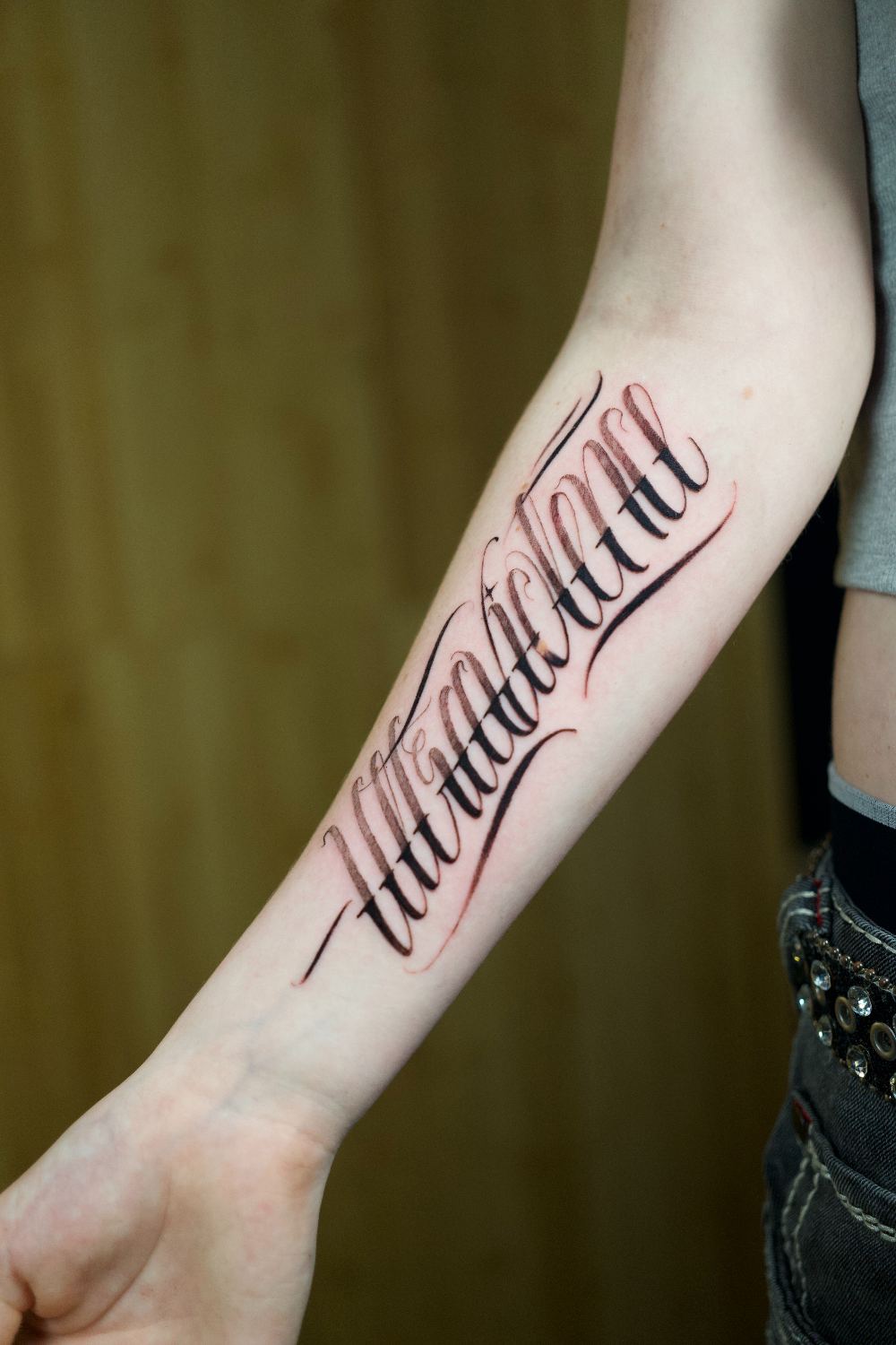 fine line script lettering forearm tattoo by Antwan Rodriguez, West Palm Beach FL