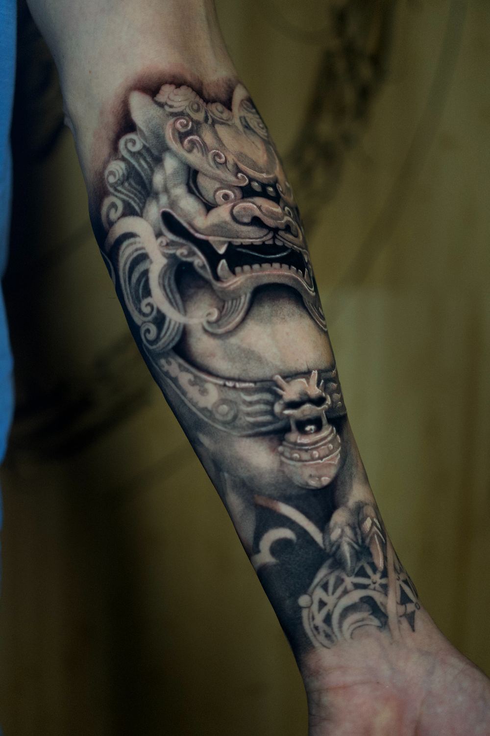 black and gray foo dog forearm tattoo by Antwan Rodriguez, West Palm Beach FL