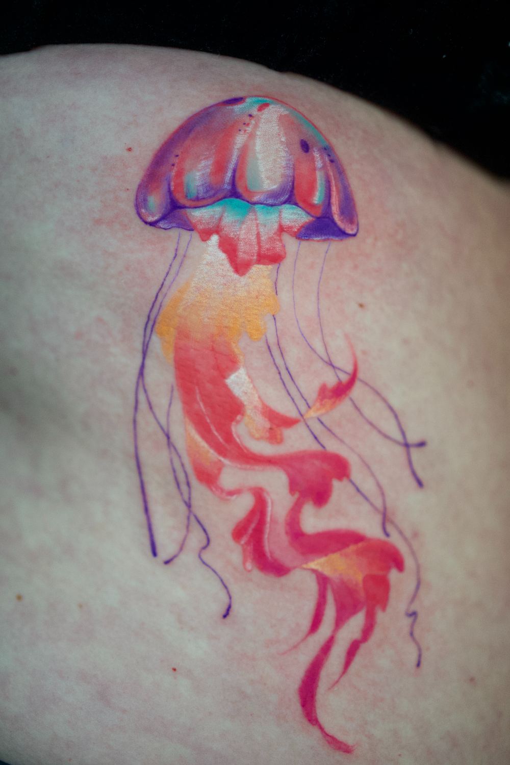 watercolor jellyfish shoulder tattoo by Antwan Rodriguez, West Palm Beach FL