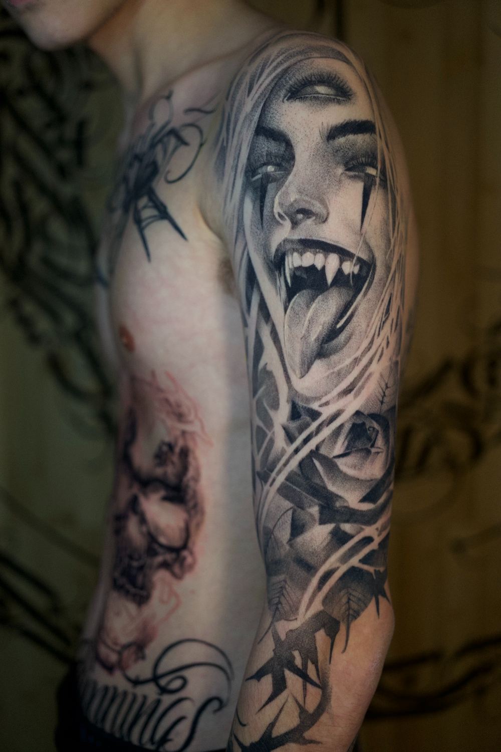 black and gray anime inspired fanged portrait thigh tattoo by Antwan Rodriguez, West Palm Beach FL