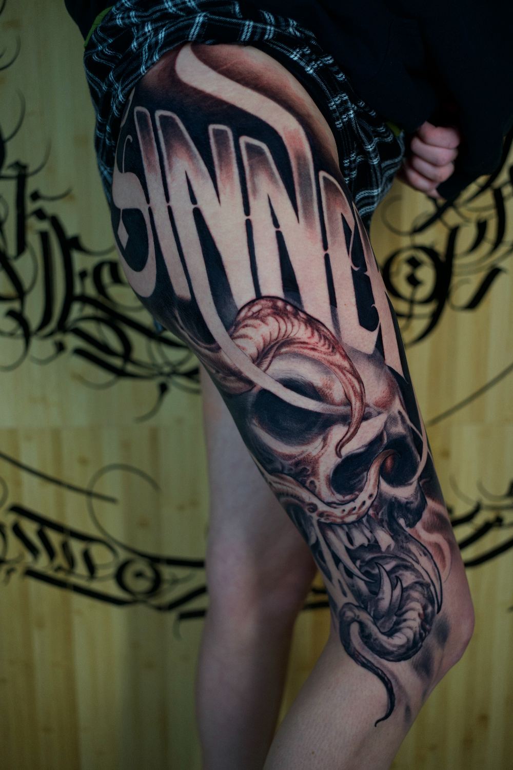 black and gray skull and ornament knee tattoo by Antwan Rodriguez, West Palm Beach FL
